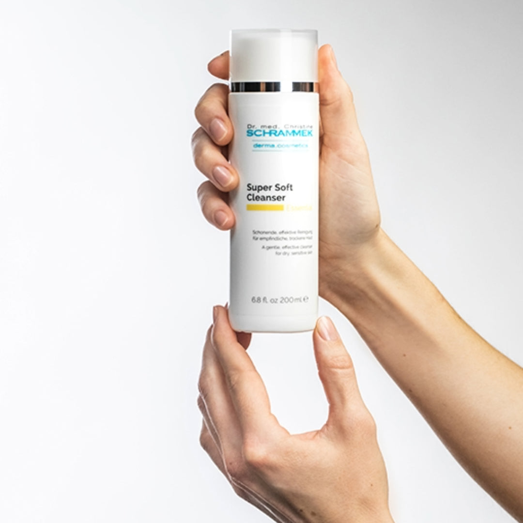 Silky cleansing milk being gently massaged onto skin, showcasing its creamy texture and nourishing formula enriched with Avocado and Jojoba Oils.