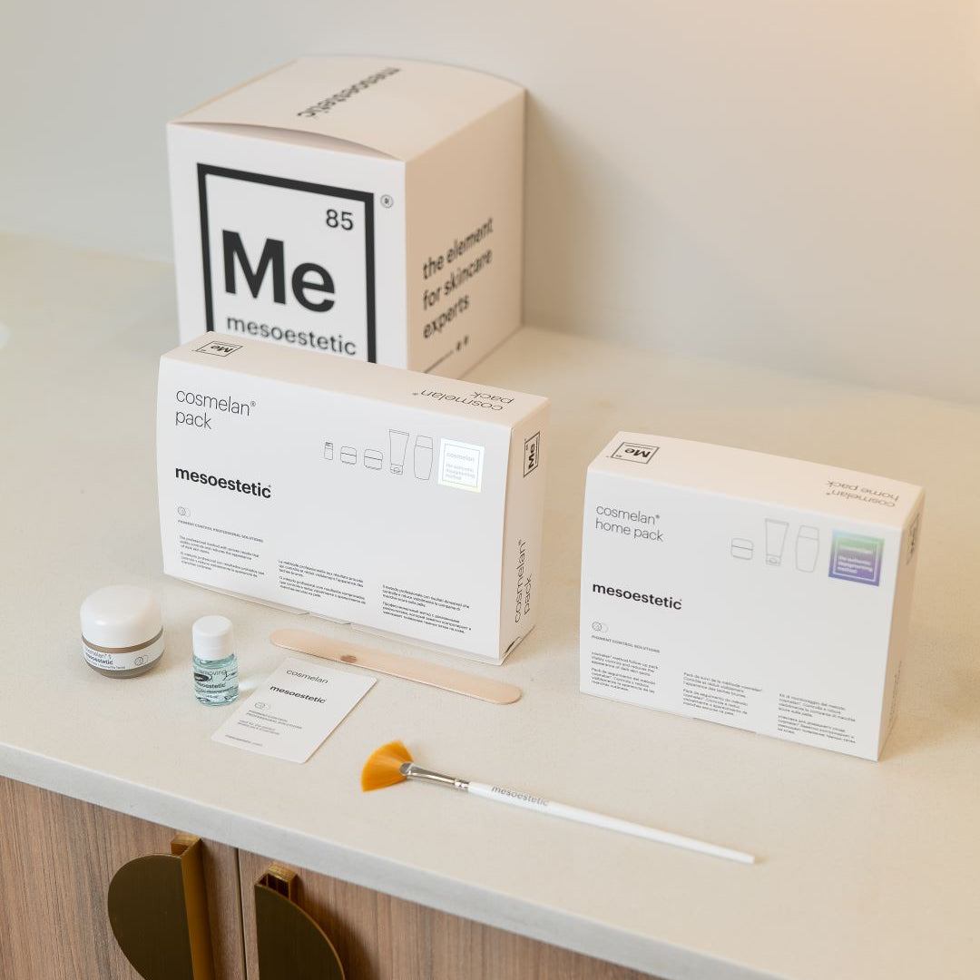 Cosmetic packaging and tools on a shelf with Mesoestetic branding.