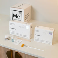 Cosmetic packaging and tools on a shelf with Mesoestetic branding.