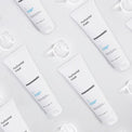 Multiple bottles of mesoestetic hydravital mask on a light gray background
